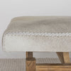 close up view of the cream leather stitching on a Corcovado large creamy white cowhide bench seat on a teak wood base.