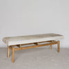 angled view of the light colored hair on hide bench ottoman by corcovado designs