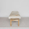 end view of the light colored hair on hide bench ottoman by corcovado designs