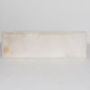 full front view of the light colored hair on hide bench ottoman by corcovado designs