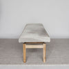 gray and cream colored bench ottoman shown from the end view by corcovado designs