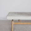 close up view of the gray and cream colored bench ottoman