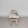 End view of the hide bench seat in cream and gray tones by Corcovado Design