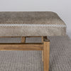 a close up view of the Hide bench seat in cream and earthy tones by Corcovado Design