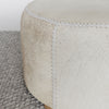 close up of the round hair on hide ottoman coffee table in grey and cream tones by corcovado designs