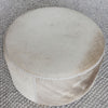 top view of the round hair on hide ottoman coffee table in grey and cream tones by corcovado designs