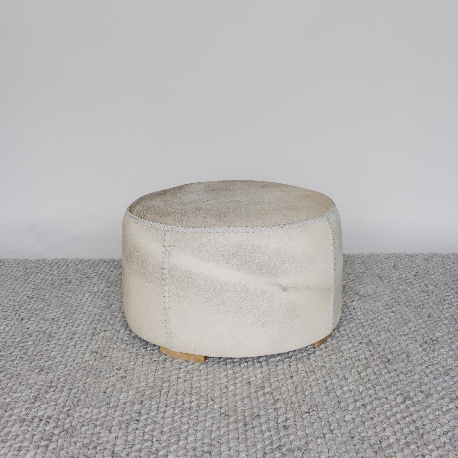 round light colored cowhide ottoman coffee table or footstool from corcovado designs 