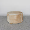 caramel brown colored round hair on hide ottoman coffee table