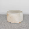 light colored cowhide ottoman coffee table with small teak wood feet