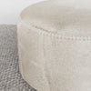 close up of the light cream colored hair on hide ottoman from corcovado designs