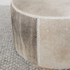 dark gray and brown colored hair on hide round ottoman coffee table