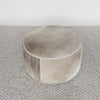 top view of the dark gray and brown colored hair on hide round ottoman coffee table