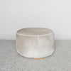 dark gray and brown colored hair on hide round ottoman coffee table