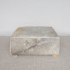 square hide ottoman with gray and caramel tones