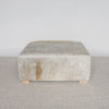 square hide ottoman with gray and caramel tones