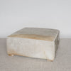 square hide ottoman with gray and caramel tones