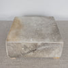 square hide ottoman with gray and caramel tones