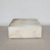 caramel brown and creamy colored square hide ottoman coffee table