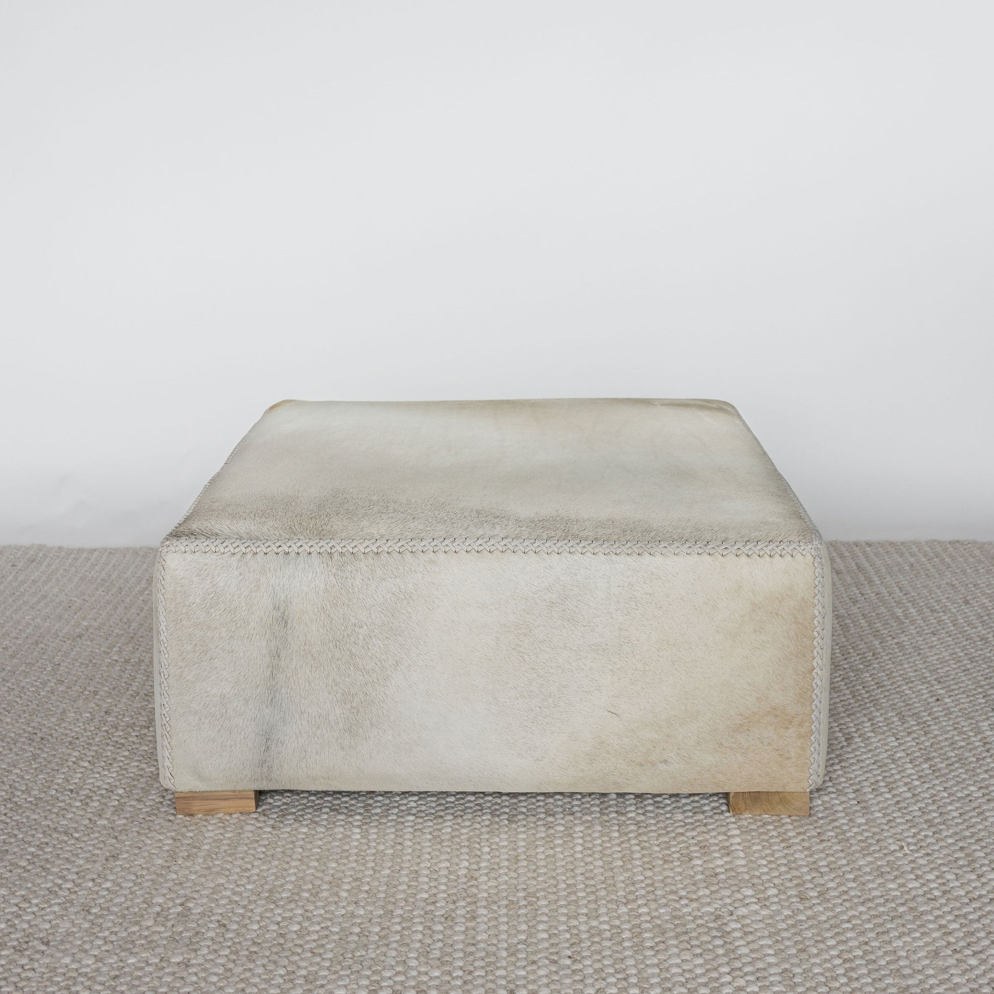 light creamy colored square hide ottoman coffee table 