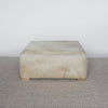 light creamy colored square hide ottoman coffee table