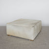 light creamy colored square hide ottoman coffee table