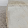 close up view showing the leather stitching detail on our light colored square hair on hide ottoman coffee table