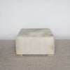 square cowhide ottoman coffee table in light tones with small teak wood feet