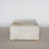 square cowhide ottoman coffee table in light tones with small teak wood feet