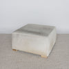 angled view of the square hair on hide ottoman coffee table by corcovado designs