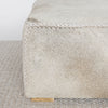 close up view of the square cowhide coffee table ottoman in earthy tones and gray by corcovado design