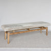 angled view of the wide gray and cream colored cowhide bench seat from corcovado