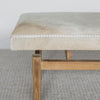 close up view of wide gray and cream colored cowhide bench seat from corcovado