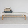 front view with 3 cushions on top of a light colored cowhide ottoman bench seat from corcovado designs