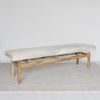 angled view of a  light colored cowhide ottoman bench seat from corcovado designs