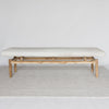 front view of a  light colored cowhide ottoman bench seat from corcovado designs