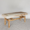 angled view of the caramel cream colored cowhide bench seat by Corcovado