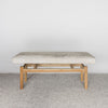 front view of a cream and gray colored hide ottoman bench by Corcovado