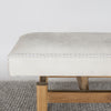 close up showing the leather hand stitching on a cream and gray colored hide ottoman bench by Corcovado