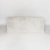 full front view showing the top of a cream and gray colored hide ottoman bench by Corcovado