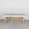 front view of a cream and gray colored hide ottoman bench by Corcovado