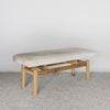 angled view of a cream and gray colored hide ottoman bench by Corcovado