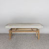 front view of a  an earthy cream colored cowhide bench seat from corcovado