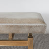 close up view of a  an earthy cream colored cowhide bench seat from corcovado