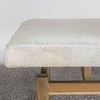 close up view of  an earthy cream colored cowhide bench seat from corcovado