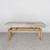 front view of a  an earthy cream colored cowhide bench seat from corcovado