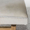 close up to show the stitching on the a cream colored light cowhide ottoman bench seat from Corcovado Designs