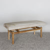 angled view of a cream colored light cowhide ottoman bench seat from Corcovado Designs