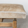 detailed view of the he caramel colored cowhide bench seat