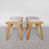 end view of the pair of small cowhide bench seat stools with white and grey hide