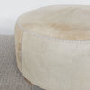 close up view of extra large cowhide round ottoman in light colored tones